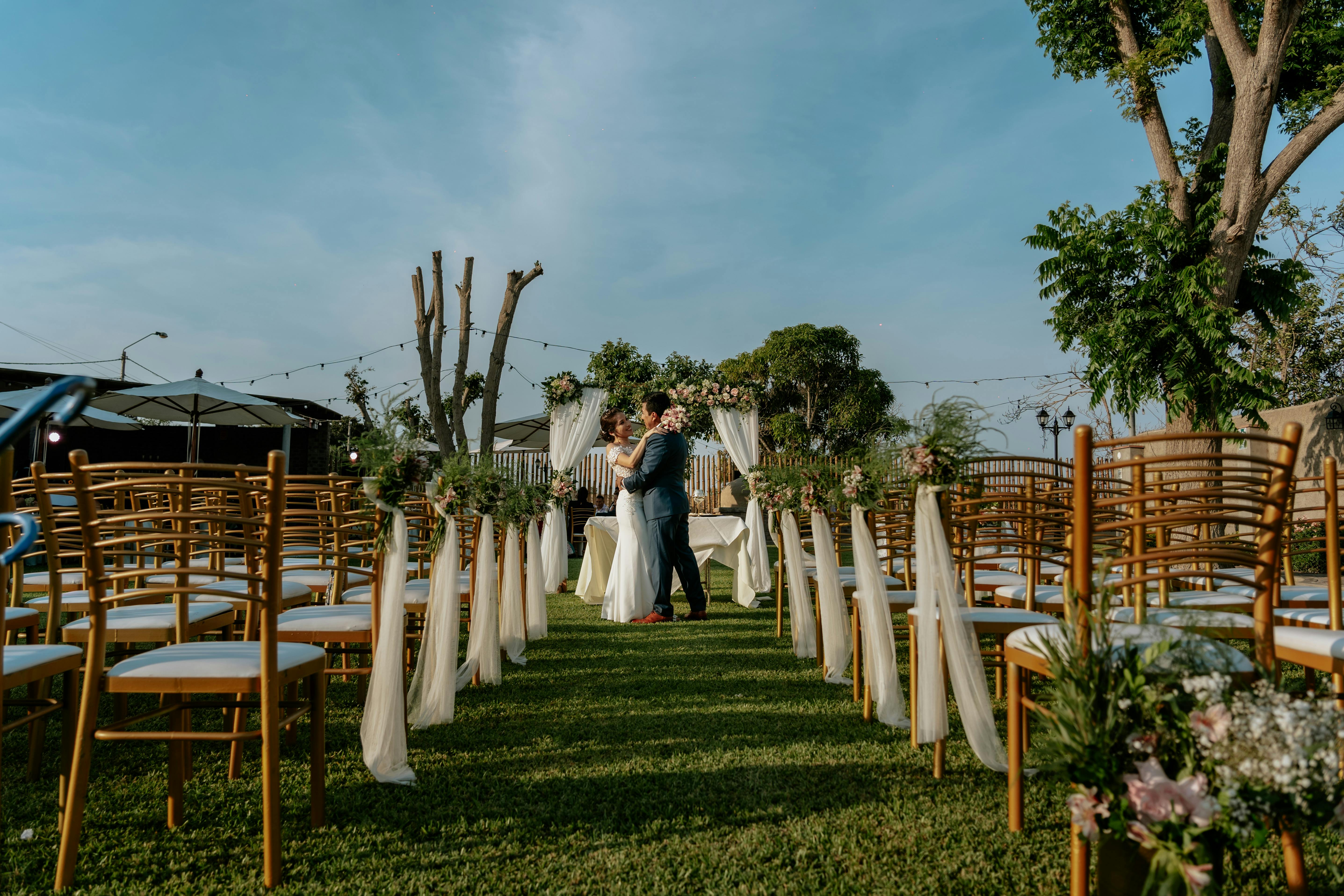 Wedding ceremony setup with an elegant outdoor aisle and floral styling